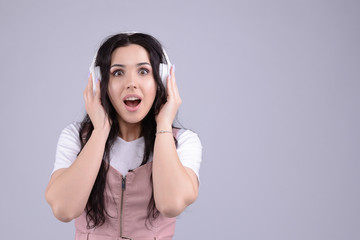 Wonderful cheerful beautiful young caucasian brunette woman found her favourite track in playlist....