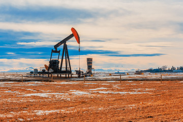 Oil Well Pumping on a Barren Landscape