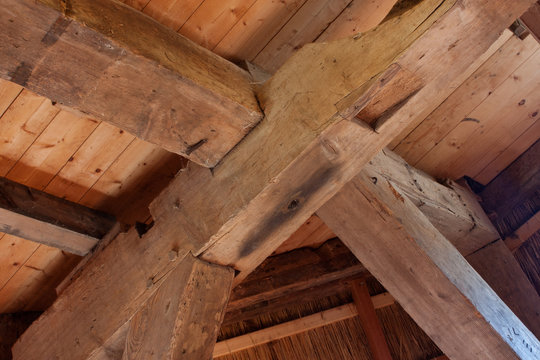 Detail of an old heavy timber frame, a post and beam construction in an antique building