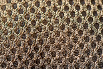 Golden dotted texturised technological seamless fabric or surface closeup