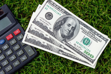 One hundred American dollars and a calculator