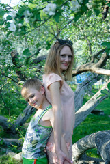 woman with child looking on the blossom tree