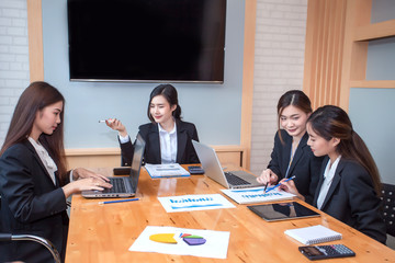 Group of businesswoman working in the office discussing documents and ideas at meeting