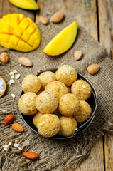 raw vegan mango coconut almond balls with fresh mango