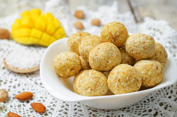 raw vegan mango coconut almond balls with fresh mango