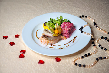 Trout fish dish in a white plate on a vintage tablecloth. Restaurant menu.