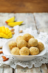 raw vegan mango coconut almond balls with fresh mango