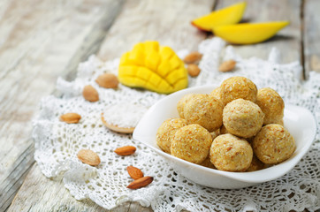 raw vegan mango coconut almond balls with fresh mango
