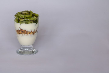 white yogurt, cereal and  kiwi fruit
