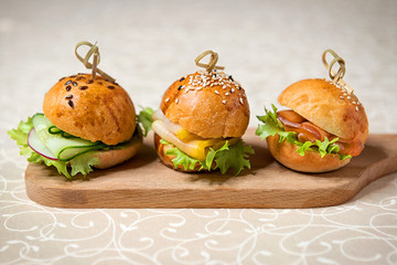 Miniburgers for the buffet on the kitchen board. Restaurant menu.