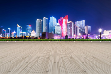 Fototapeta premium Empty Plaza Floor Bricks and the Skyline of Modern Urban Architecture in Qingdao..