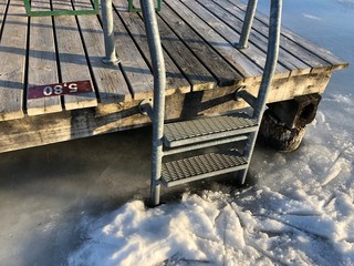 pool ladder in a frozen winter lake