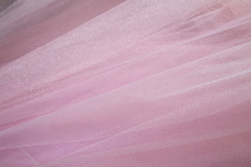  draped background of pink powdery fabric in the form of tulle, texture