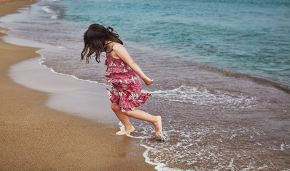 Kids playing on sea side beach with blue water clowdy day at Antalya