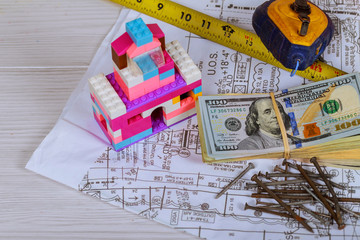 american money on architectural blueprints finances and one hundred dollar bills