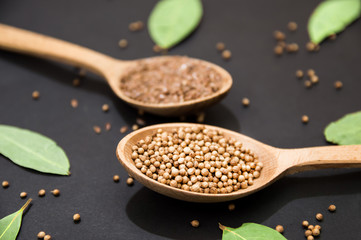 wooden spoons with pepper and flax seeds top view