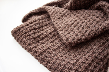 Fototapeta na wymiar Knitting. Knitting. Knitted scarf. Brown scarf. Knitted pattern
