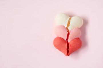 Heart shaped macarons on a pink background for Valentine's day
