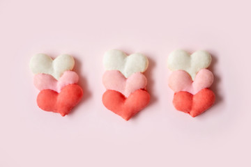 Heart shaped macarons on a pink background for Valentine's day