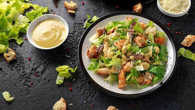 Caesar salad with chicken, anchous fish, croutons, parmesan cheese and greens. healthy food