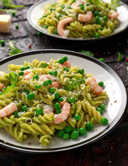 Italian pasta in a creamy pesto sauce with shrimp, prawns