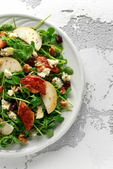 Pear, chicken salad with blue cheese, cranberry and walnuts. concept healthy food