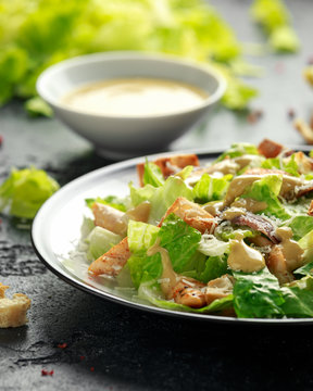 Caesar salad with chicken, anchous fish, croutons, parmesan cheese and greens. healthy food