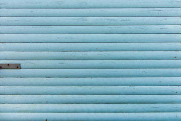 Section of light green wood panelling from a seaside beach hut. Perfect as a background for Summer Holiday or seaside themes.