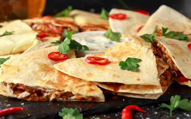 Mexican quesadilla with chicken, cheese and peppers, yogurt dip and chilli.