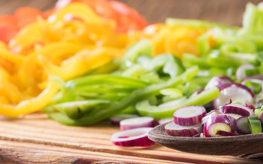 green onion and red, green and yellow chili peppers cut in julienne