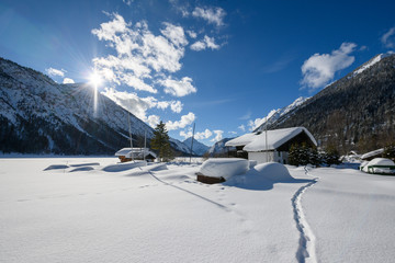 boat house in sunny winter with lot snow at lake plansee
