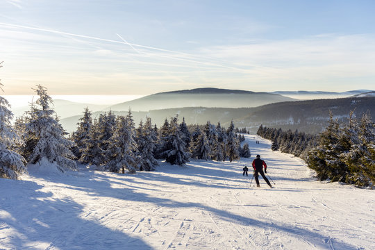 Lonely skier freeriding in beautiful winter scenery during sunset.