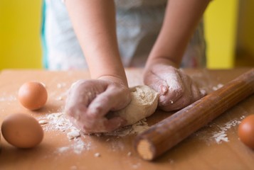 close up scene of female hands making dough
