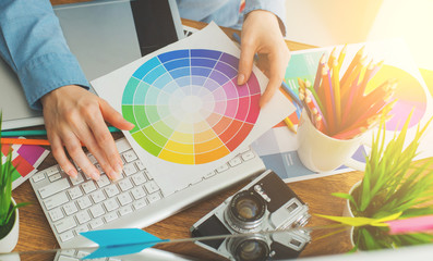 Young cute Graphic designer using graphics tablet to do his work at desk view from above