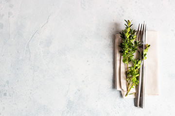 Spring table setting. Light concrete background. Top view. Copy space.