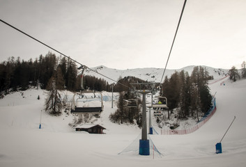 Obraz premium Ski chairlift at the ski slopes Aosta Valley, Italy .