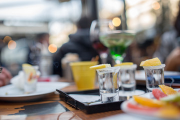 shot glass filled with tequila service with lemon and salt