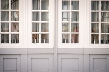 Large windows with candles. White and gray colors. Copenhagen, Denmark. Details