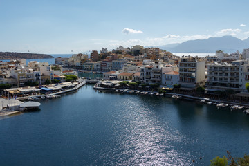 Fototapeta premium View over a beautiful, picturesque town of Agios Nikolaos, Crete, Grete and small Voulismeni lake and a port.
