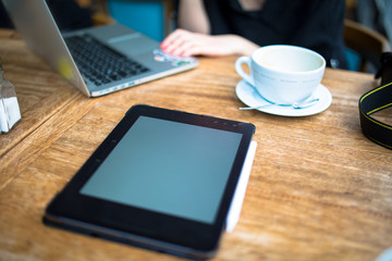 young adult businessperson working on laptop with coffee pro pad and pencil on the table