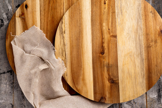 Top View Flatlay Set Of Wooden Trays And Table Cloth At Wooden Table Background.