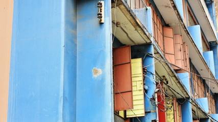 Fototapeta na wymiar Blue-pink-yellow facade of apartment building in Ongpin Street. Binondo District-Chinatown-Manila-Philippines-0999