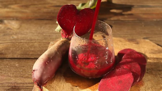 beet  juice in glass on wooden table
