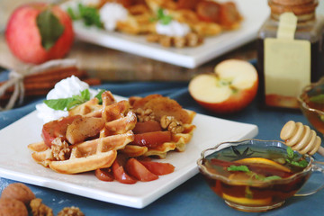 waffles sered with walnuts, honey and baked aples