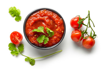 bowl of mexican salsa sauce isolated on white background, top view