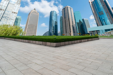 Empty square floor tiles and skyline of modern urban buildings in Shanghai..