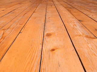 a full frame perspective view of old worn timber planking with a grainy textured surface used for flooring