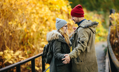 Fototapeta premium Two young travel couple walking on bridge
