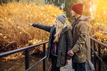 Two young travel couple walking on bridge