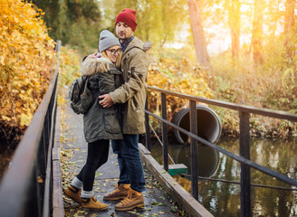 Two young travel couple walking on bridge